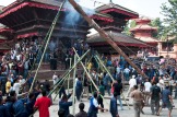People raising the Indra Dhoj ( wooden pole ) at Kathmandu Durbar Square marking the start of Indra Jatra festival. Photo © Senén Germade