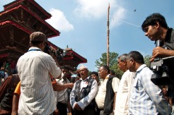 People raising the Indra Dhoj (wooden pole) at Kathmandu Durbar Square marking the start of Indra Jatra festival. Photo © Senén Germade